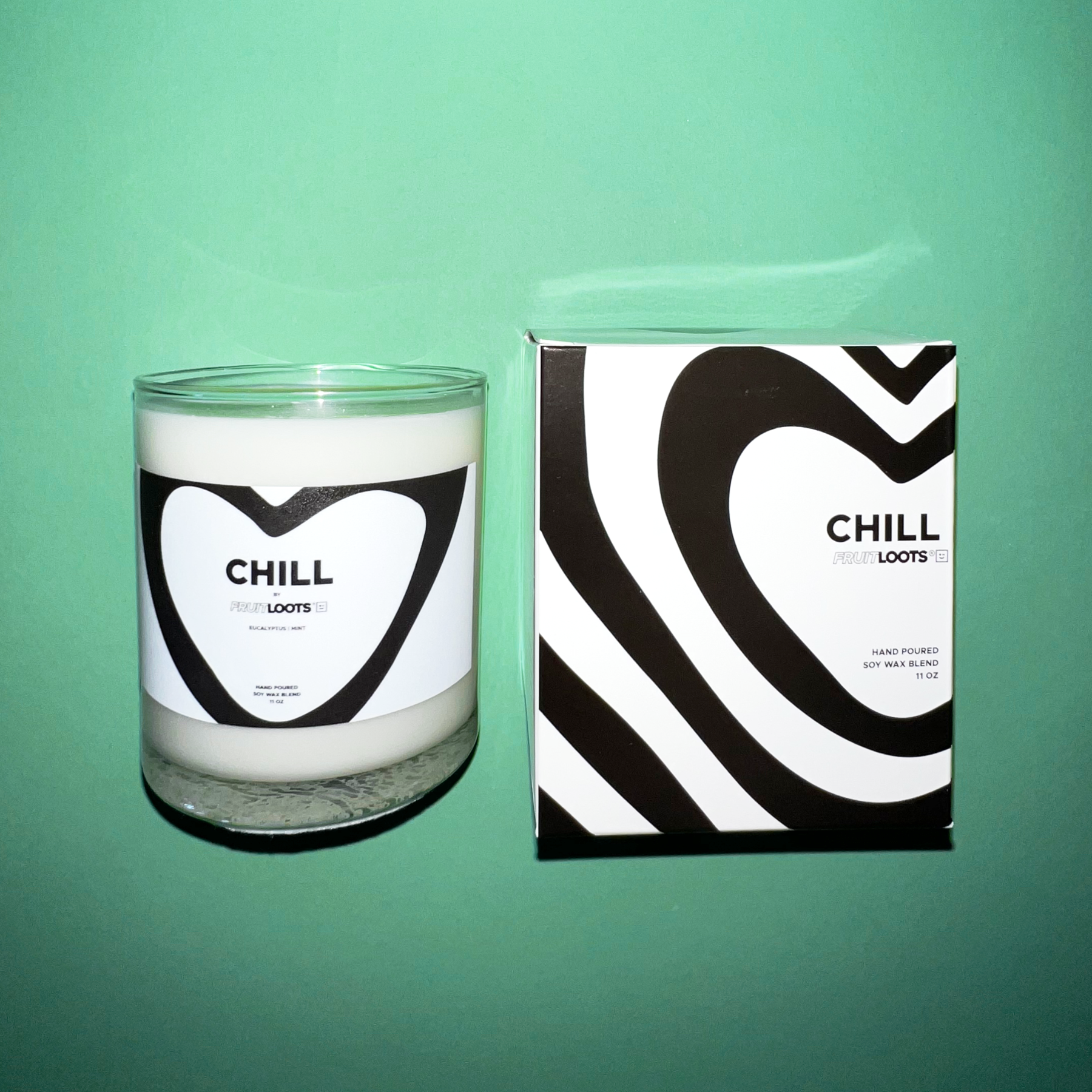 Chill Candle features clear vase with black and white modern heart design. Box replicates the heart pattern on the front. All black and white modern design.