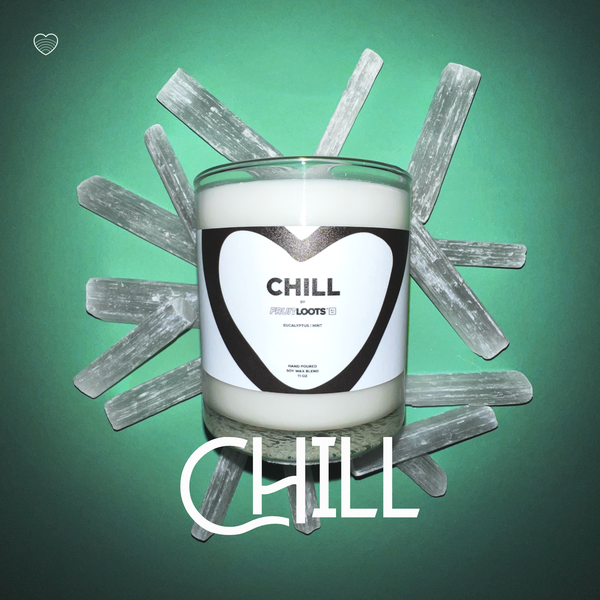 Chill Candle sitting in a bed of crystals and mint green background