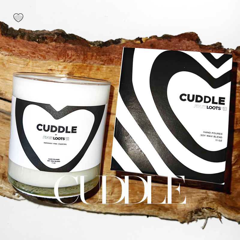 Close up of our Cuddle Candle sitting on a firewood log. 