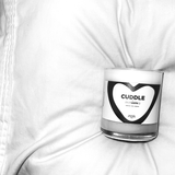 Our cuddle candle laying in a fluffy pillow.