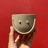 The Smile Mug by Jumie Ceramics. Handmade in Los Angeles, this handmade ceramic mug is the happiest mug in any house! With its two bright eyes and big bright smile, this is sure to become your favorite new dish. 